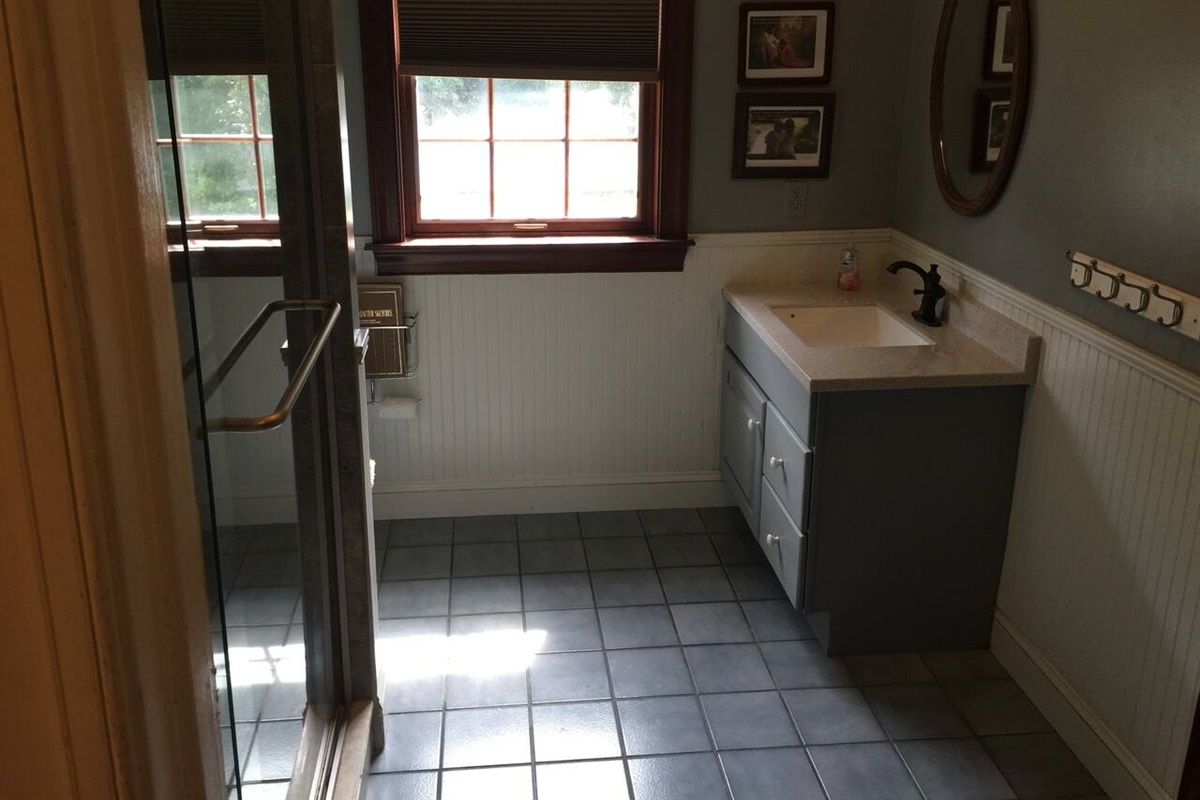 2nd bathroom on 2nd Floor that access from main hallway. Has 2 sinks and very nice  tile full shower