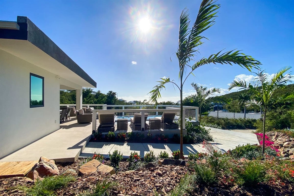 Lush tropical plants line the property pathways.