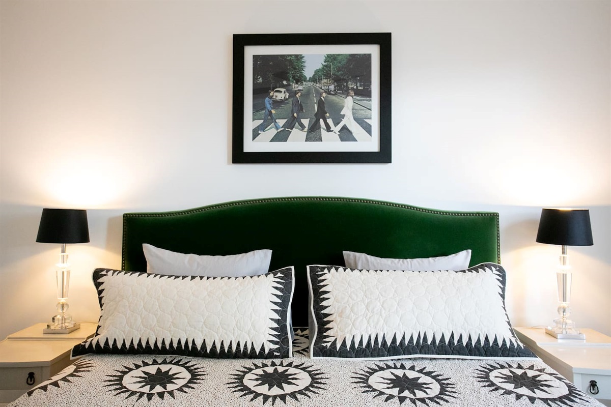Primary bedroom with a king bed, plush mattress, soft cotton linens, and blackout shades