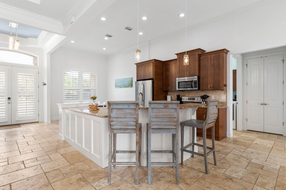 Barstools pull up to the granite island, so breakfast, snacks and card games happen right where the cook works.