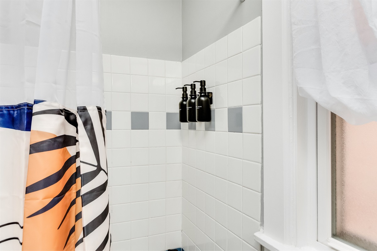 Shower Retreat: Enjoy a vibrant shower experience with stylish tiles and modern amenities!