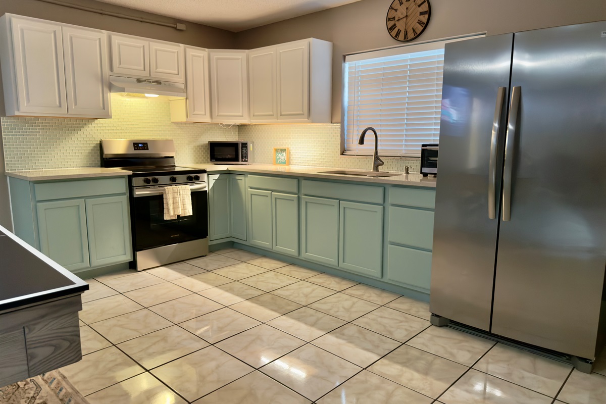 This spacious, fully-equipped kitchen combines stylish design with everyday functionality—perfect for everything from a sunrise coffee routine to a full family dinner after a day exploring.