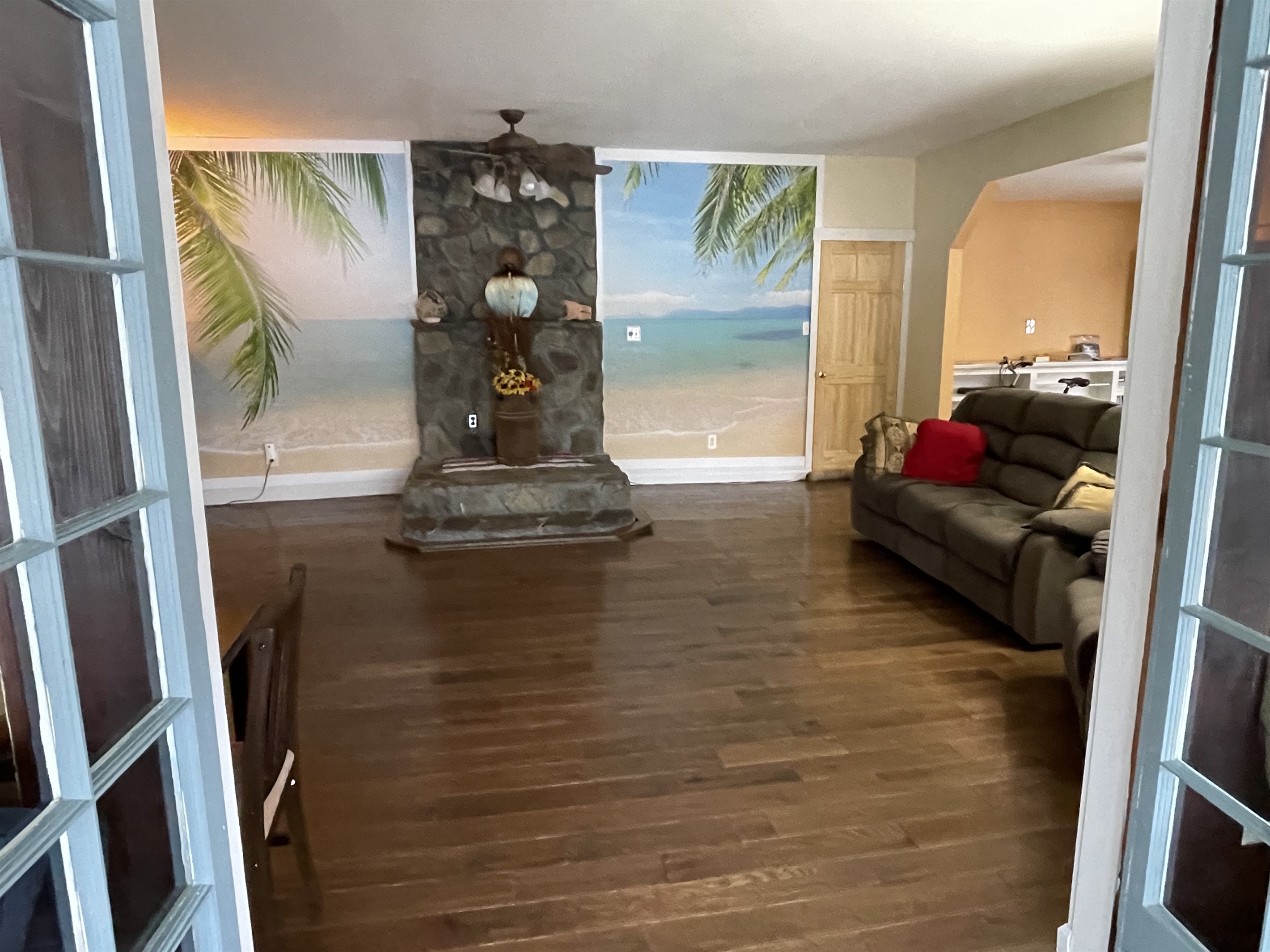 Nature's Hidden Treasure beach mural in the living room transports you to another world.