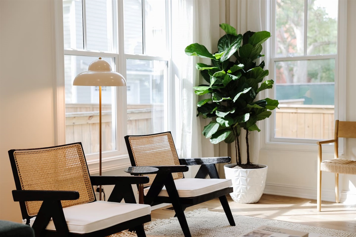 The light-filled living room features an oversized Floyd couch, a 70" smart TV and an open floor plan that flows seamlessly into the kitchen and dining areas. Great spot for hanging with a large group.