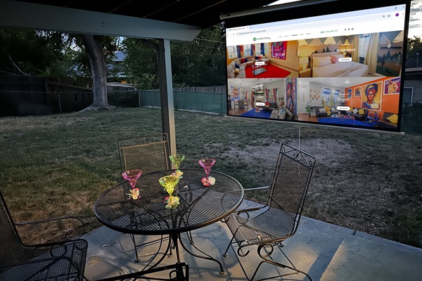 Your private backyard escape with cozy seating, a dining table, and a projector for ultimate relaxation!