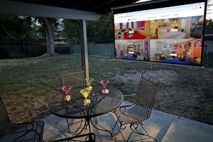 Your private backyard escape with cozy seating, a dining table, and a projector for ultimate relaxation!