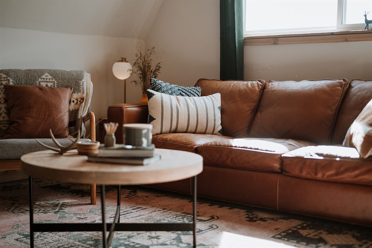 Sit down and stay awhile. The leather couch and additional seating make for a great place to hang out.