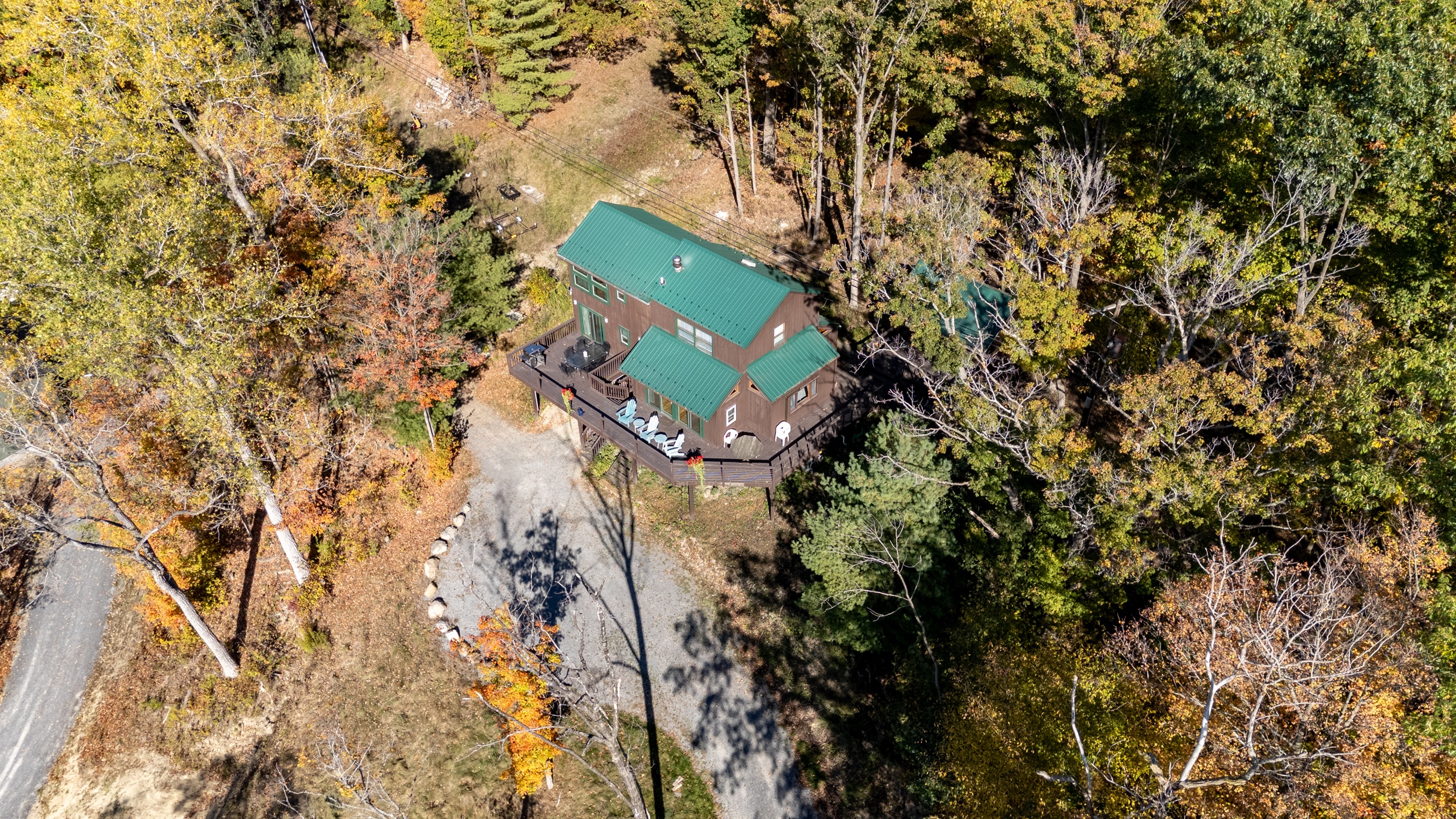 Aerial view of the cabin tucked into the trees above Keuka Lake — your hillside escape.