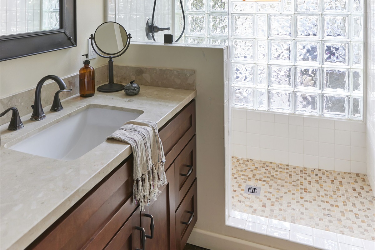 Airy bathroom with shower, bench, and all toiletries included.