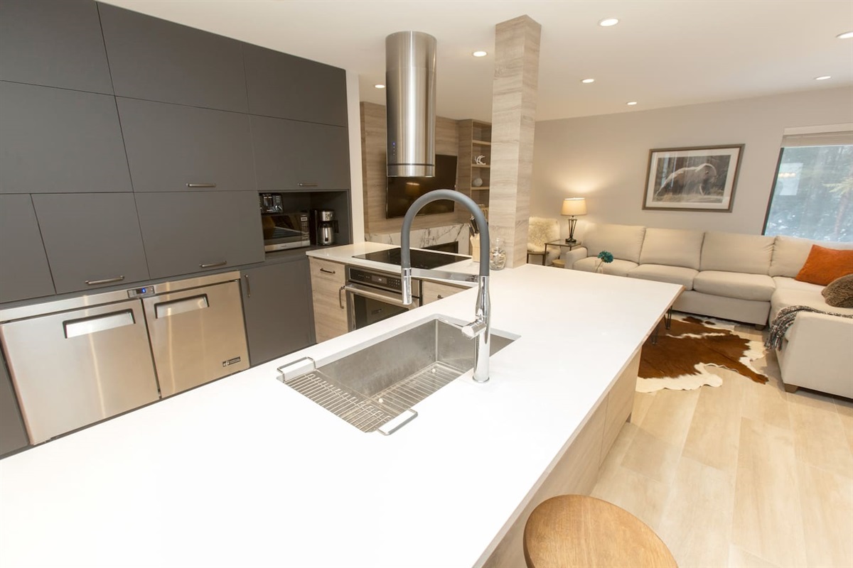 Bright modern, open concept kitchen is great for family and group gatherings. Featuring Wolf Cooktop, built-in wall oven,  commercial under counter fridge & integrated freezer.  Fully renovated great entertainment space. Good for large groups. 