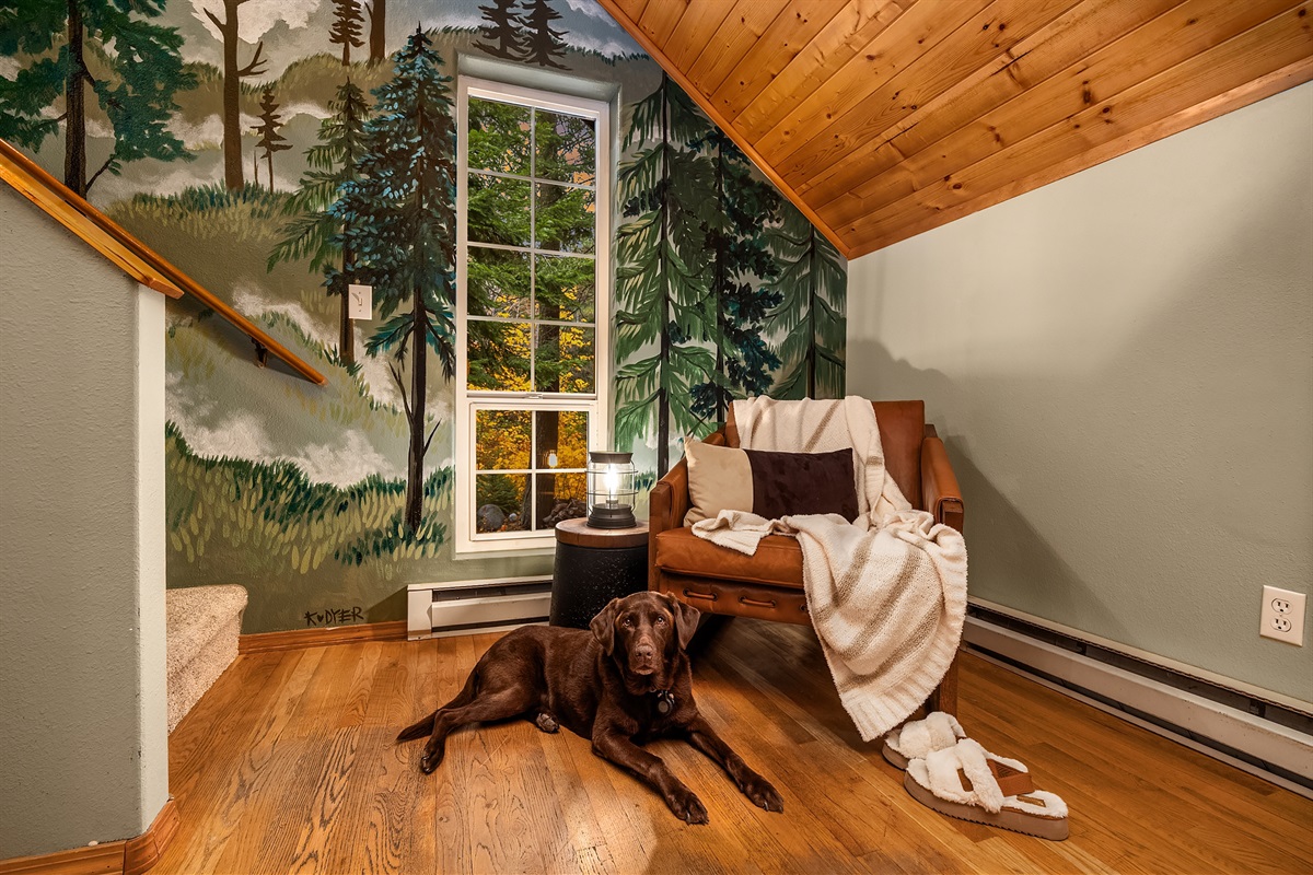 Corner sitting area / reading nook next to stunning mural