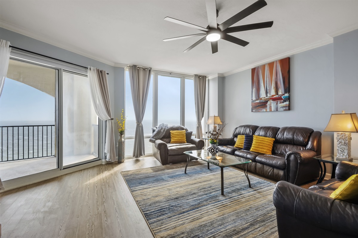 Living room, balcony, floor to ceiling windows.