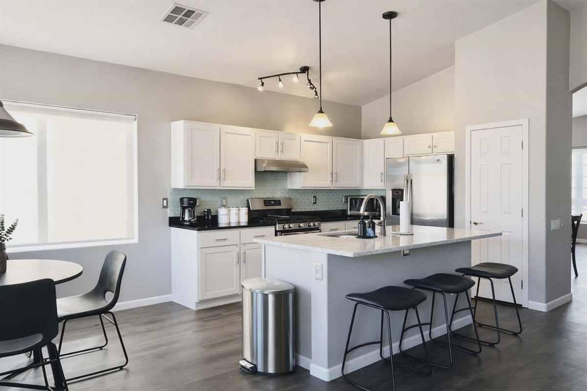Bright, open kitchen with full amenities and modern lighting — ideal for family cooking and entertaining. 