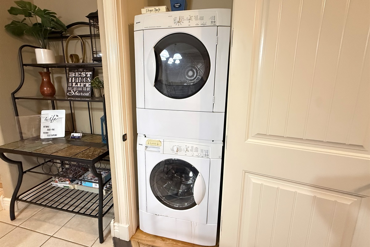 Guest laundry area featuring a stacked washer and dryer perfect for longer stays.