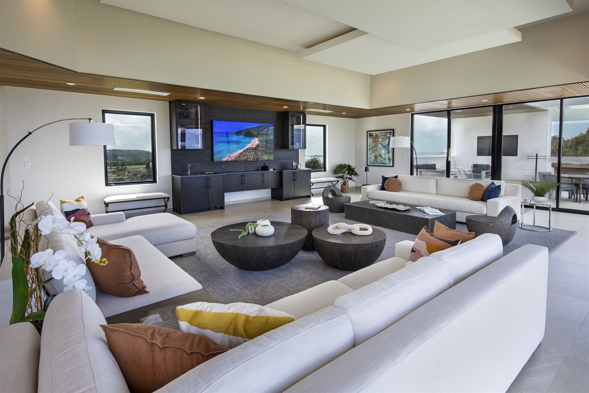 Living room has plenty of seating with wet bar