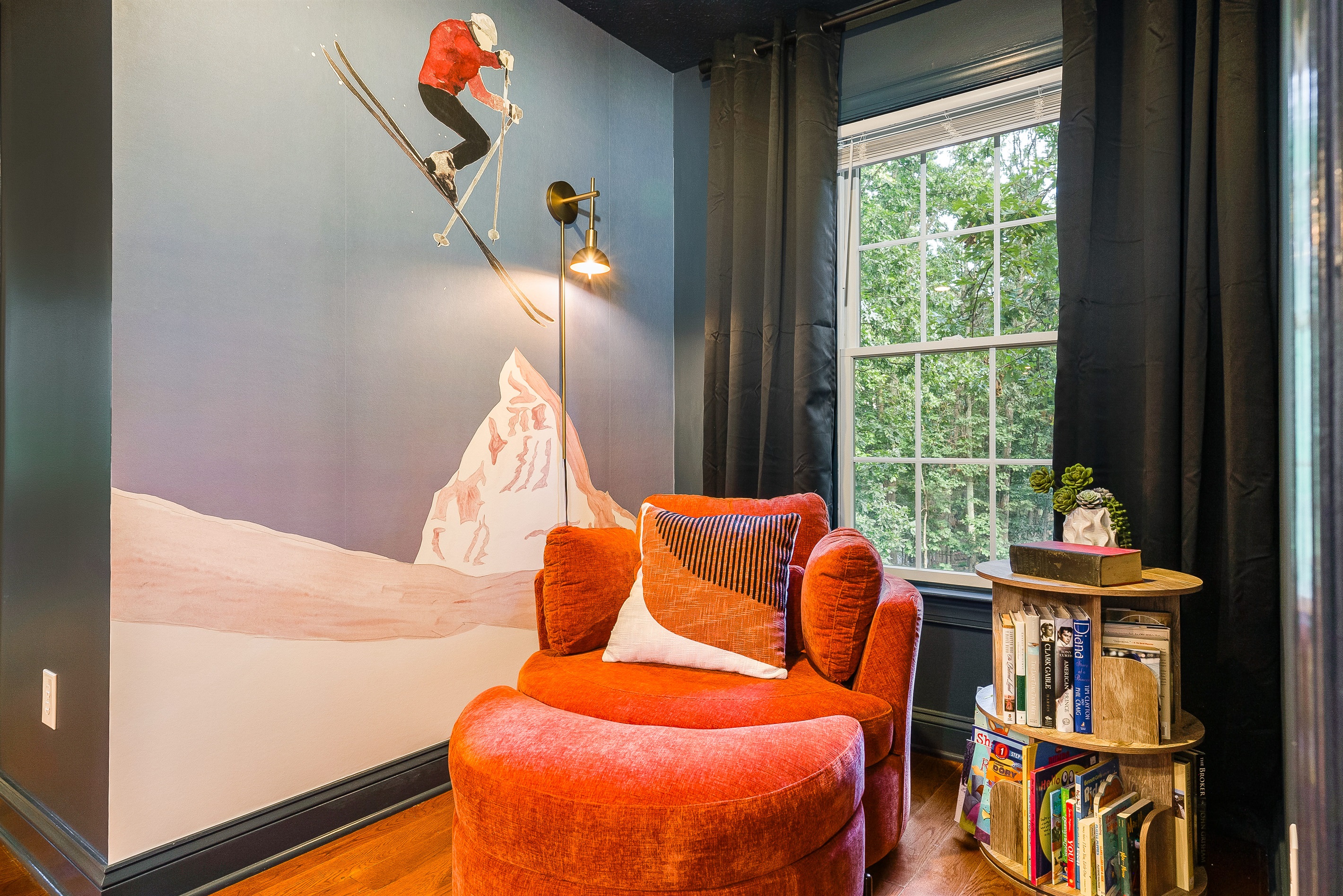 A playful mural, comfy chair, and shelves of books make this corner ideal for kids, teens, or anyone who wants to curl up and escape.