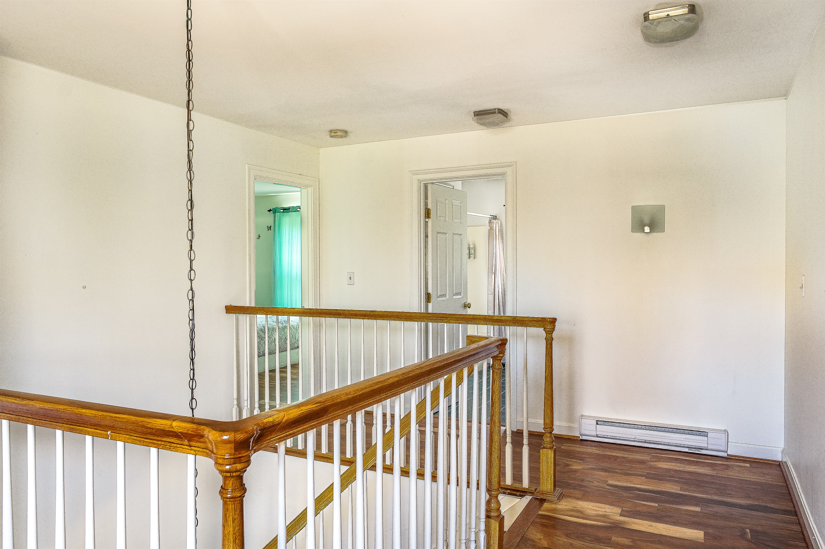The bright second-floor landing leads you to the guest quarters. To the left, you’ll find the convenient full guest bathroom and the charming "Butterfly Room," offering a private and comfortable wing for your group in Southwest Harbor.