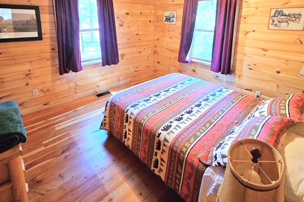 Queen bed in the main level’s bedroom.