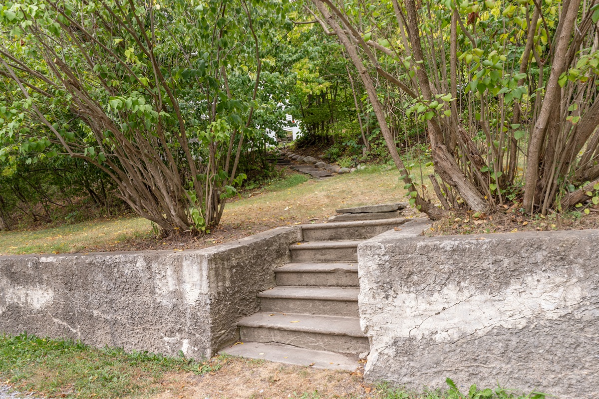 Classic stone and concrete entryway provides a unique and timeless approach to your private getaway.
