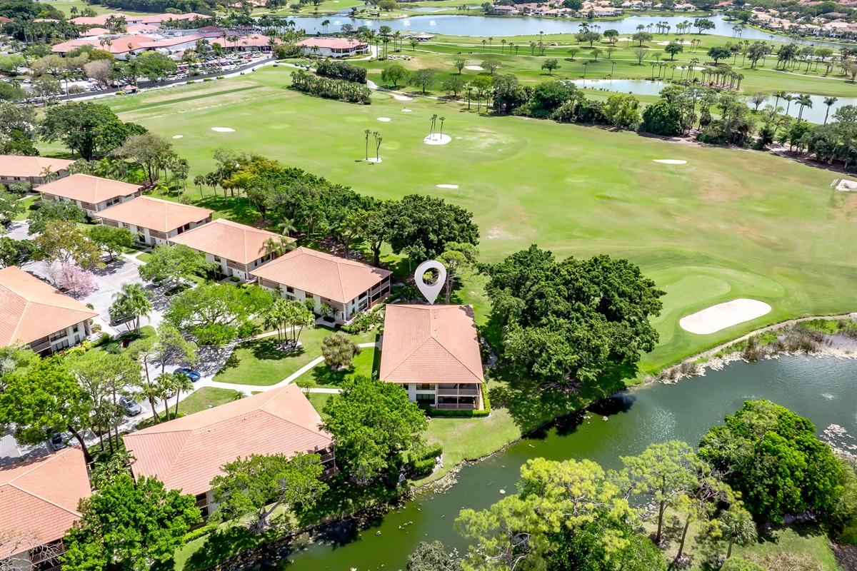 Aerial view showcasing lush golf course, water features, and serene surroundings