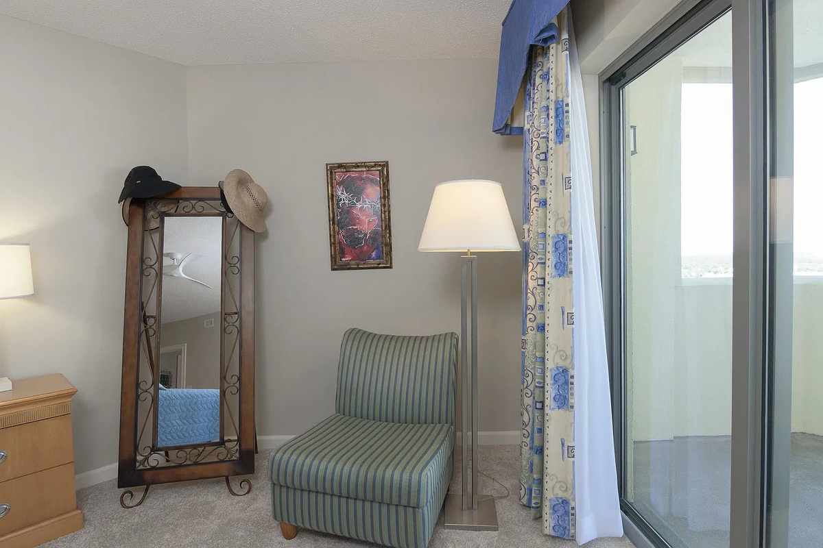 Spacious main bedroom with king bed, balcony access and ensuite
