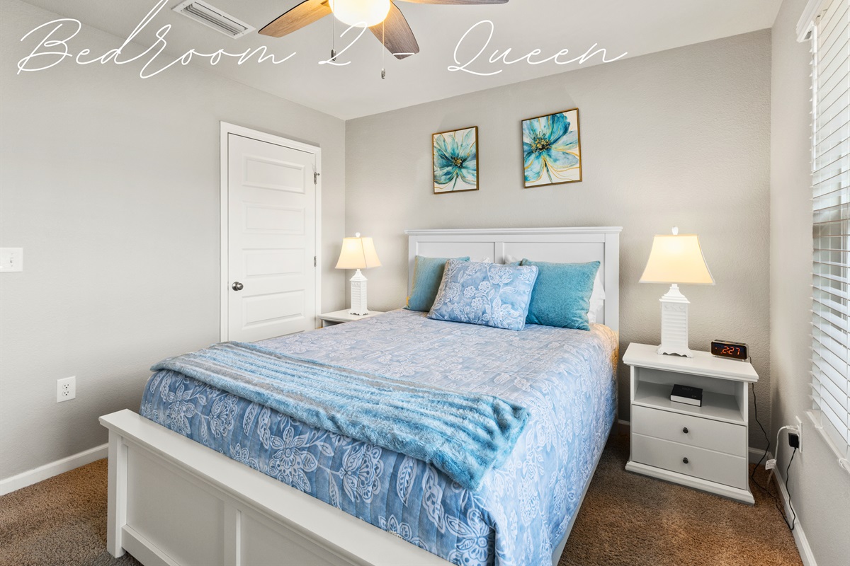 Queen bedroom with stylish coastal decor and soft bedding for sweet dreams.