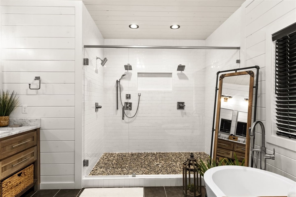 Indulge in the spa-inspired bathroom with dual vanities, a deep soaking tub, and a walk-in shower. Thoughtful touches like cozy robes and a full-length mirror make every moment feel special.