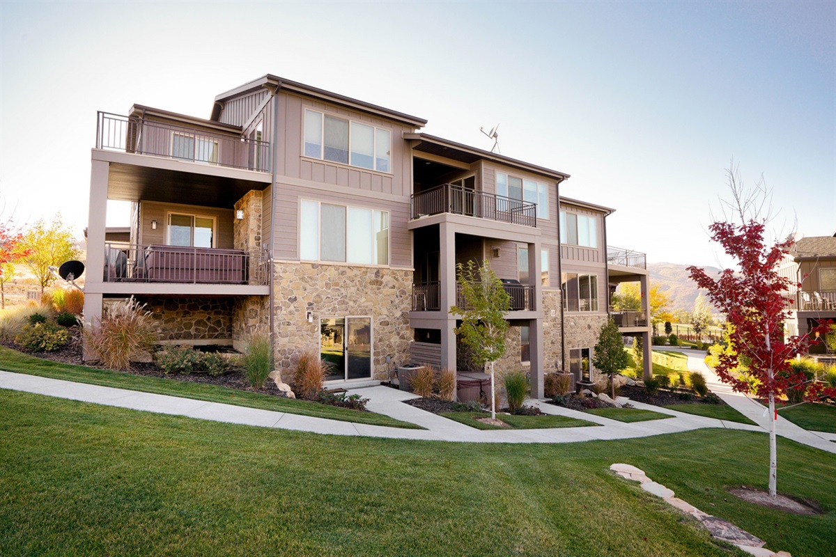 Contemporary multi-unit building with landscaped surroundings.