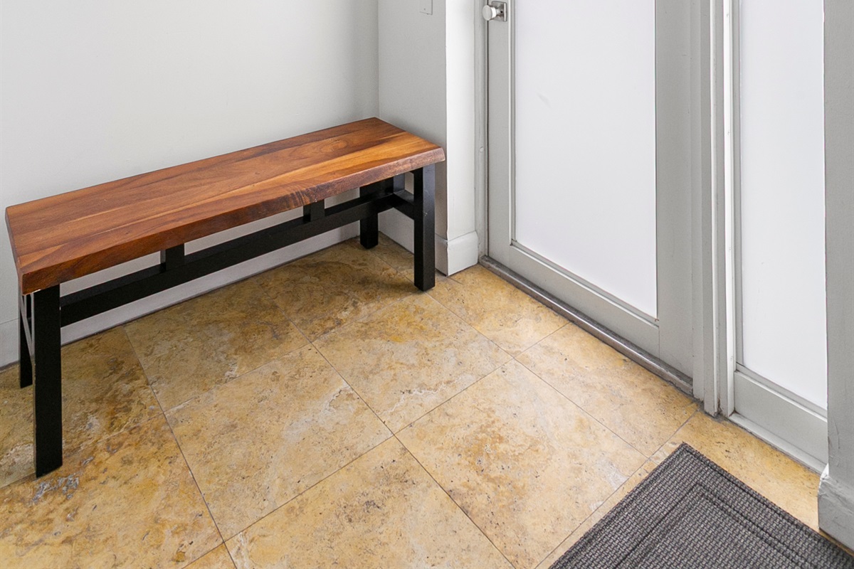 Private entrance foyer with storage space, easily accessible beach gear, and a bench
