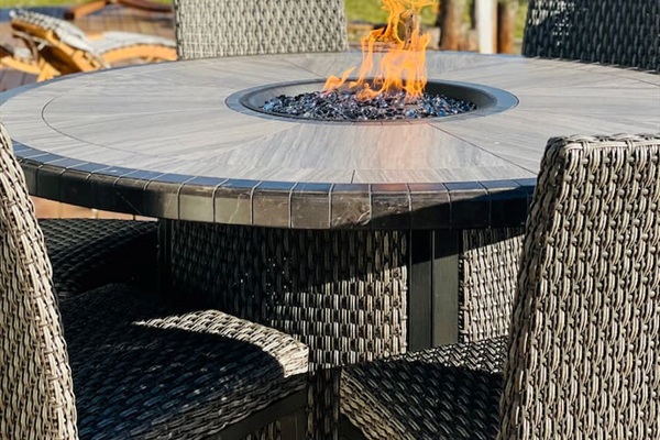 Outdoor fire pit table perfect for relaxing evening by the lake.