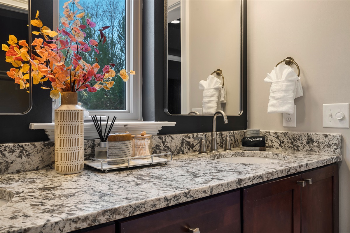 Double vanity bathroom with granite counters - ample space for getting ready during group trips