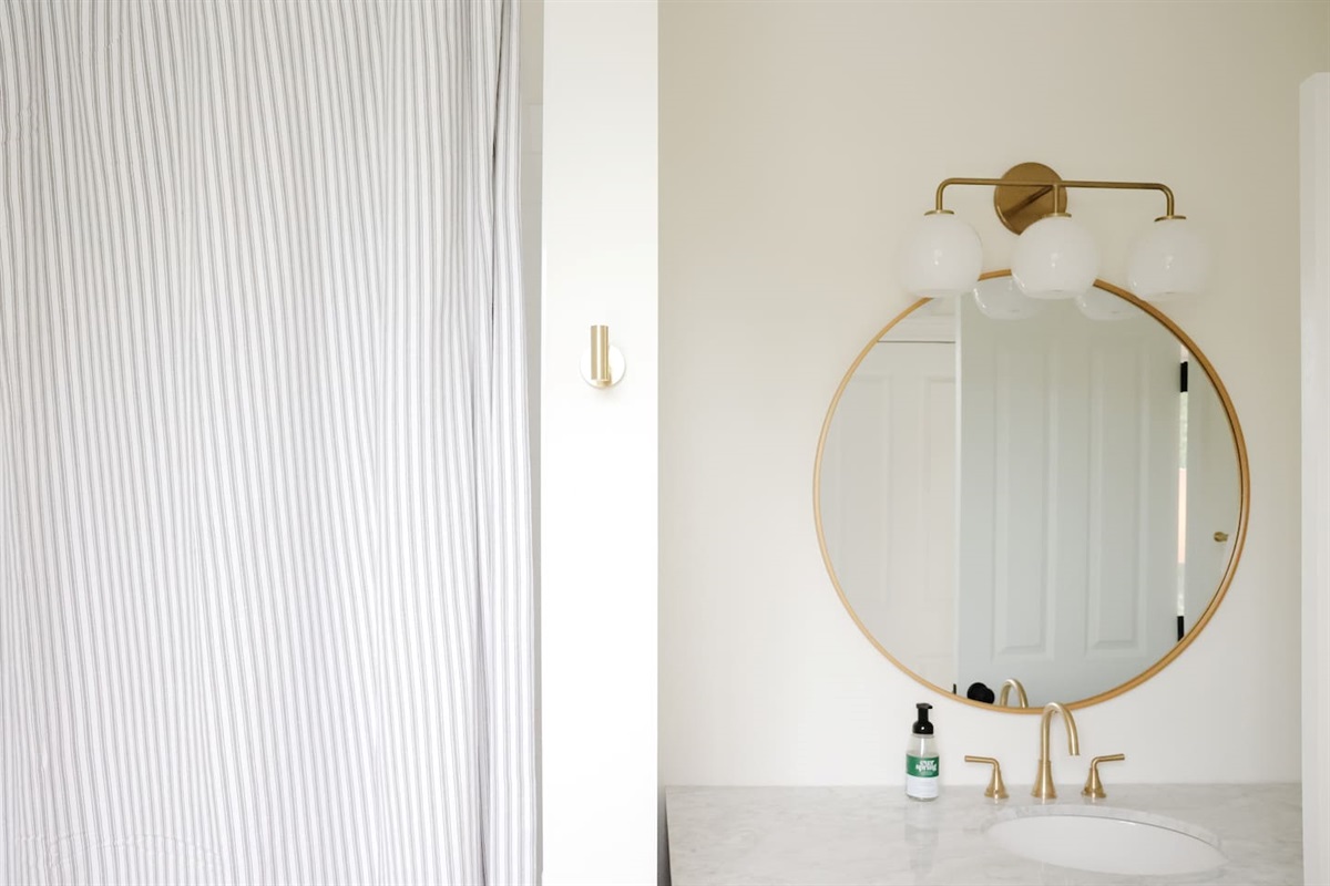 The spacious "sunrider room" features two queen beds, a spacious double-door closet, a full bath with a shower, smart TV and coastal photography. 