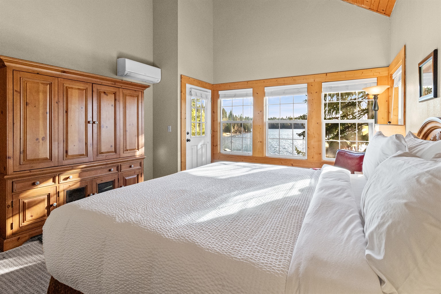 Primary king bedroom with lake-view balcony — McCall Idaho lakefront vacation home