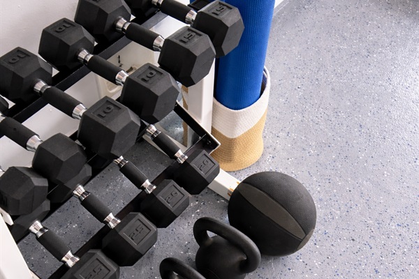 Dumbbells, kettlebells, and yoga mats for a well-rounded workout.
