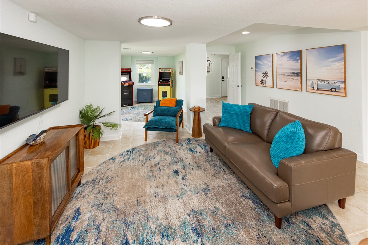 The ground floor living room area is another place to relax, play games, & watch movies