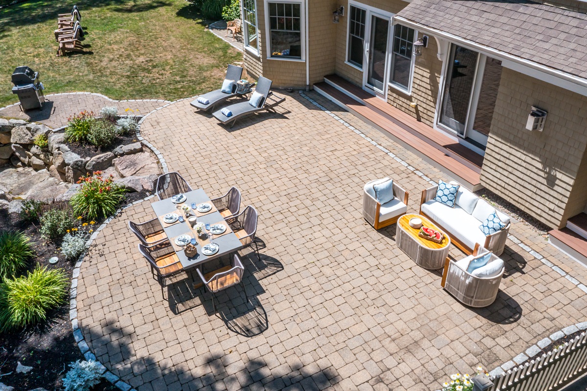 A full layout of lakeside living—grill, firepit, seating, and the water just steps away.