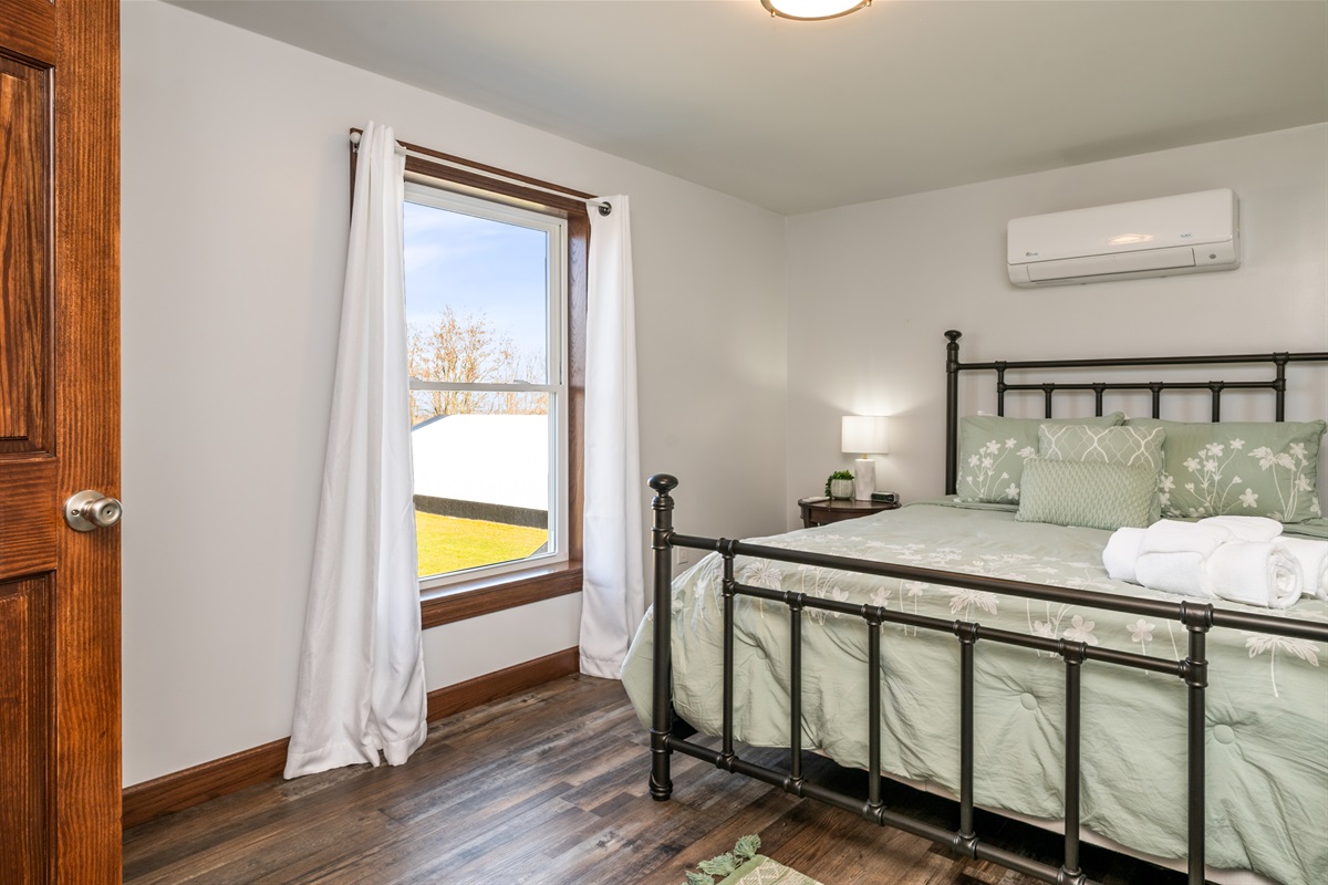 Inviting guest room with lake-country charm and soft tones. Step right out to enjoy the Finger Lakes breeze.
