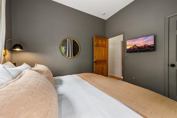 Another view of this king bedroom, offering a comfortable, quiet space to unwind with plenty of storage and privacy.