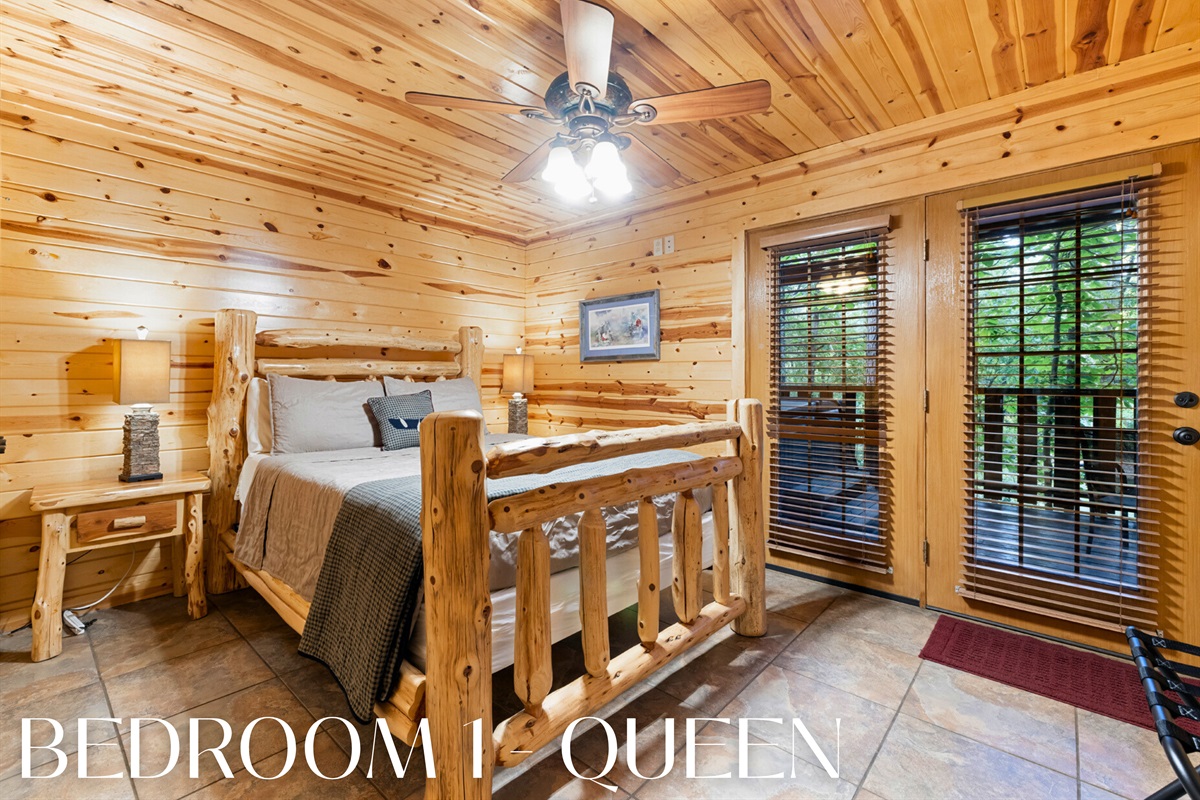 Bedroom 1 with a queen log bed and deck access.