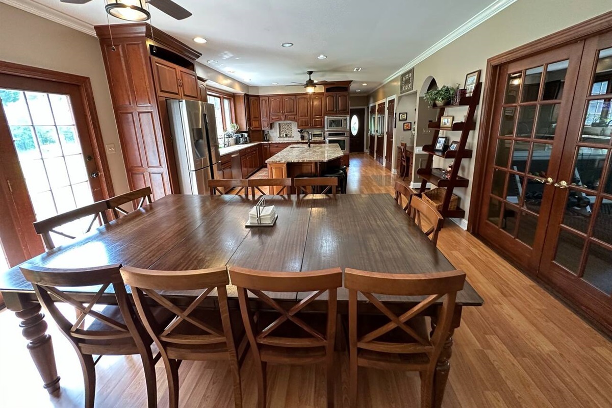 Enjoy eating at this spacious area with a large 10ftx5ft table that fits 12  people (1 chair not shown). Additional seating at the kitchen island, and a pull-up coffee table in the family room. Ceilings are 9ft.