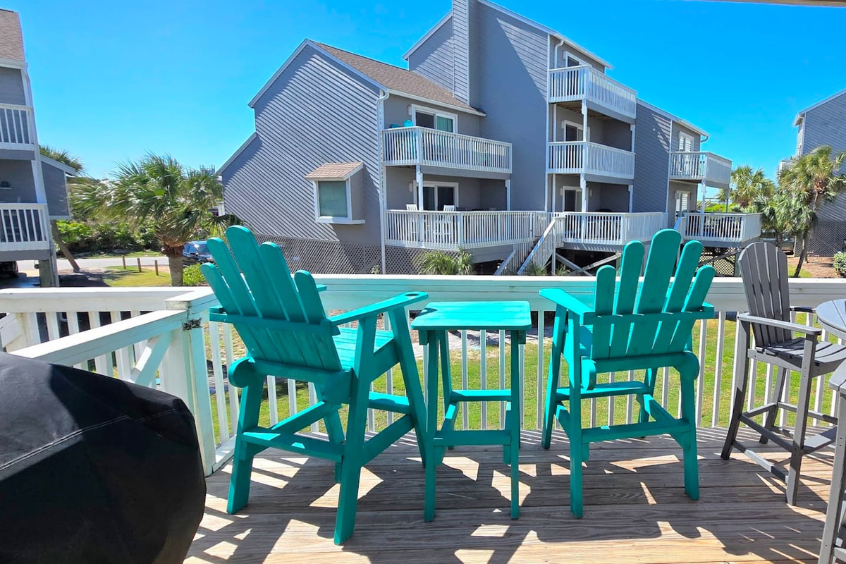 Fire up the grill and stay out here longer than planned &mdash; the deck with Adirondack chairs and dining set earns every minute after sunset.
