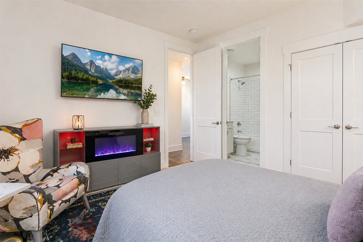 The downsairs queen bedroom with ensuite bathroom has its own cozy fireplace. With soft, cotton sheets, plentiful pillows, and mood lighting to match, you'll have everything you need for a great night of sleep in the Queen City.