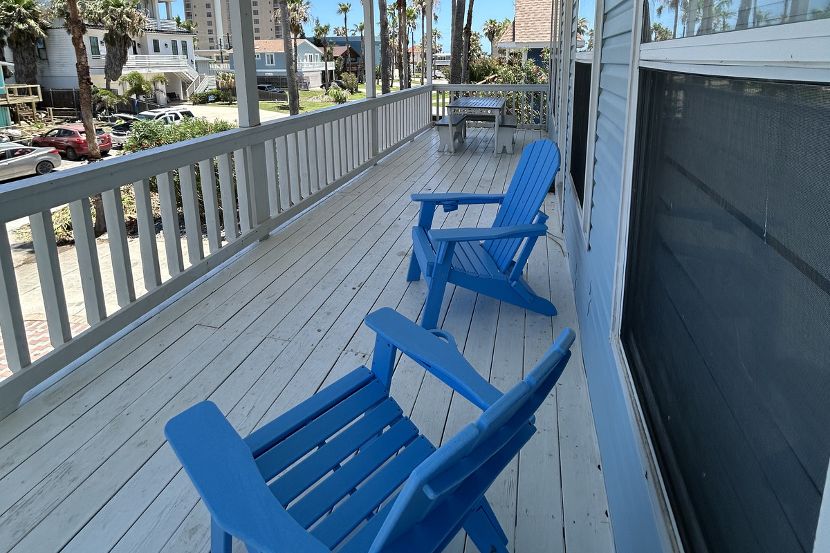 Step outside onto the spacious second-floor balcony off the main living area, where comfortable seating and island breezes create an inviting space for gathering and relaxation.