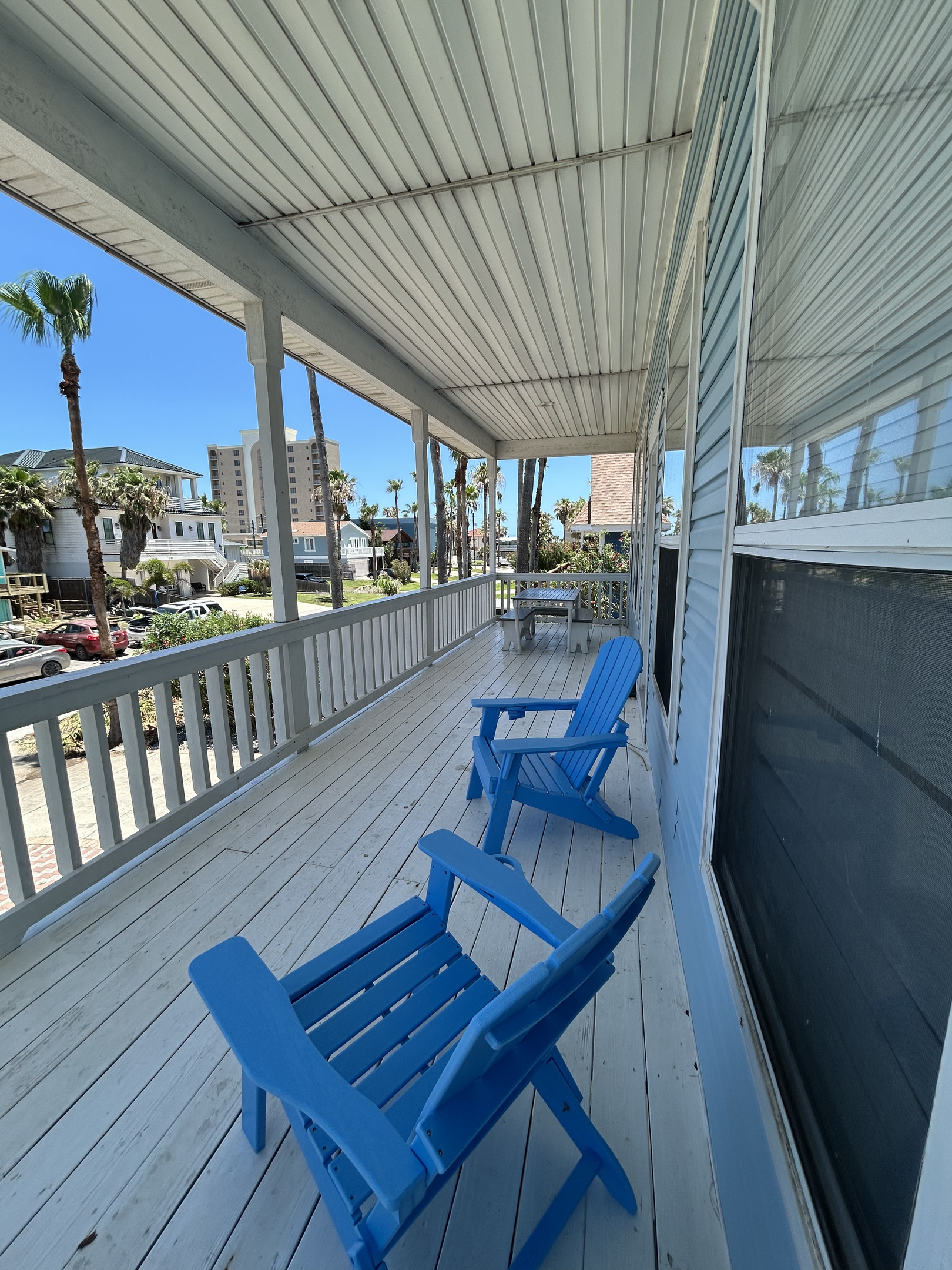 Step outside onto the spacious second-floor balcony off the main living area, where comfortable seating and island breezes create an inviting space for gathering and relaxation.