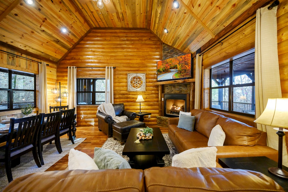 Warm, inviting living room with stone fireplace and open layout