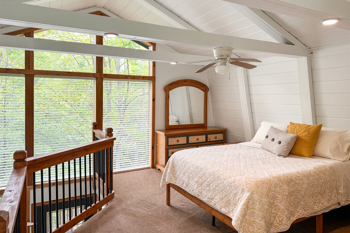 Primary loft bedroom with attached bathroom