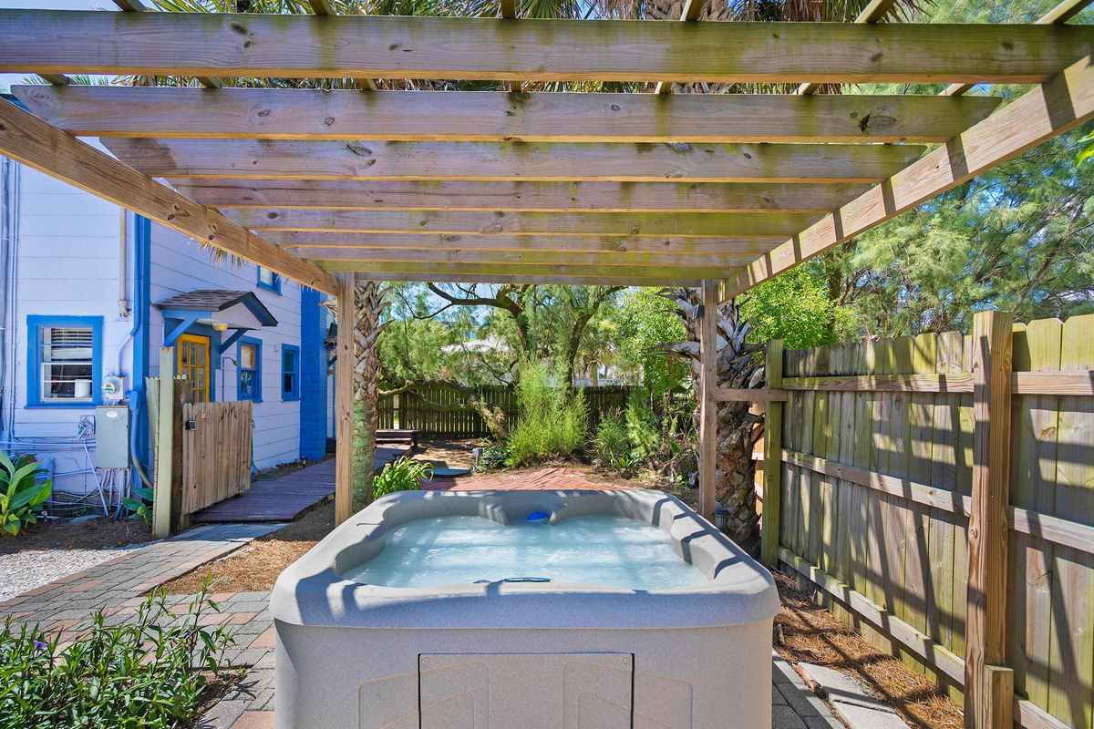 The hot tub sits in its own pocket of the garden, screened by fence and planting on every side. It is shared with the downstairs cottage, and is best enjoyed after dark once the string lights have flickered on.