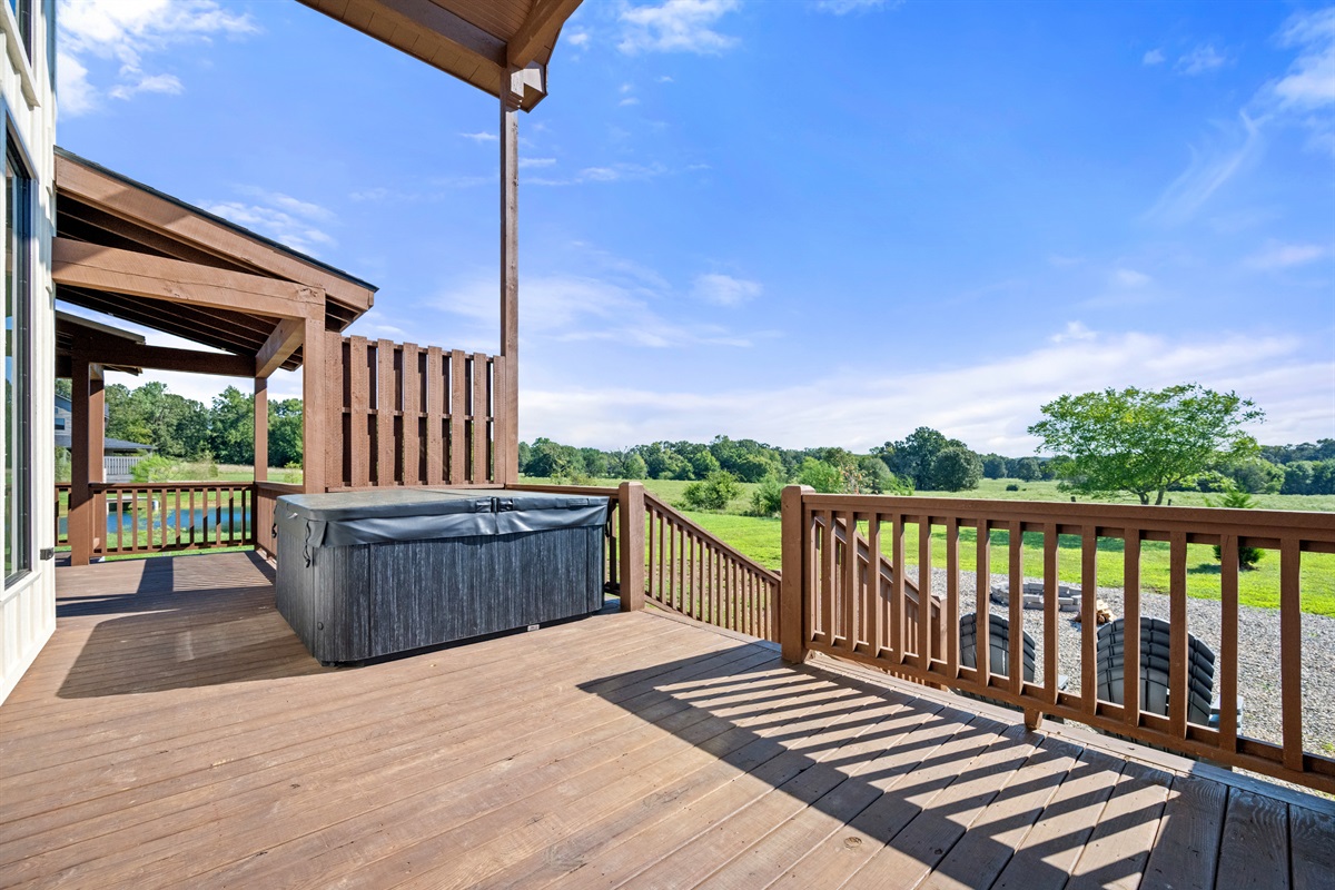 Hot tub on deck with scenic views, perfect for relaxing.