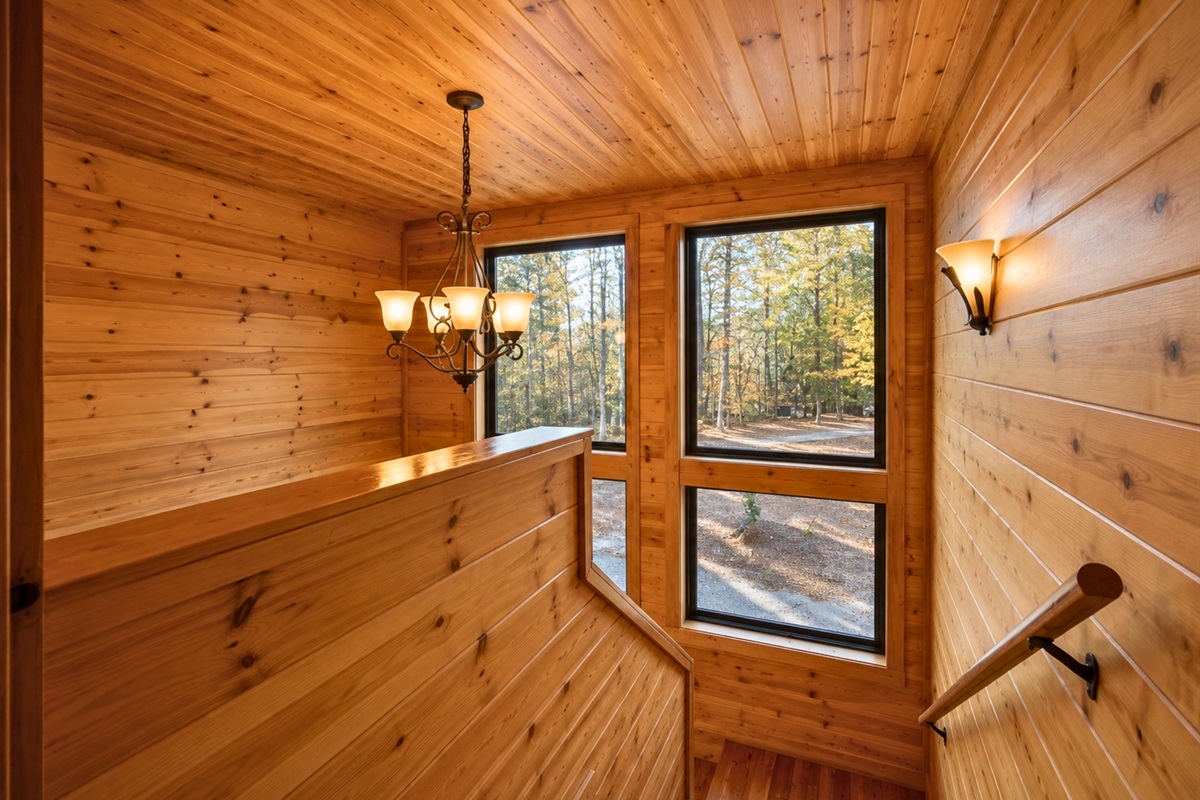 Positioned beside large windows, the soaking tub offers a peaceful place to relax while taking in the surrounding wooded views.
