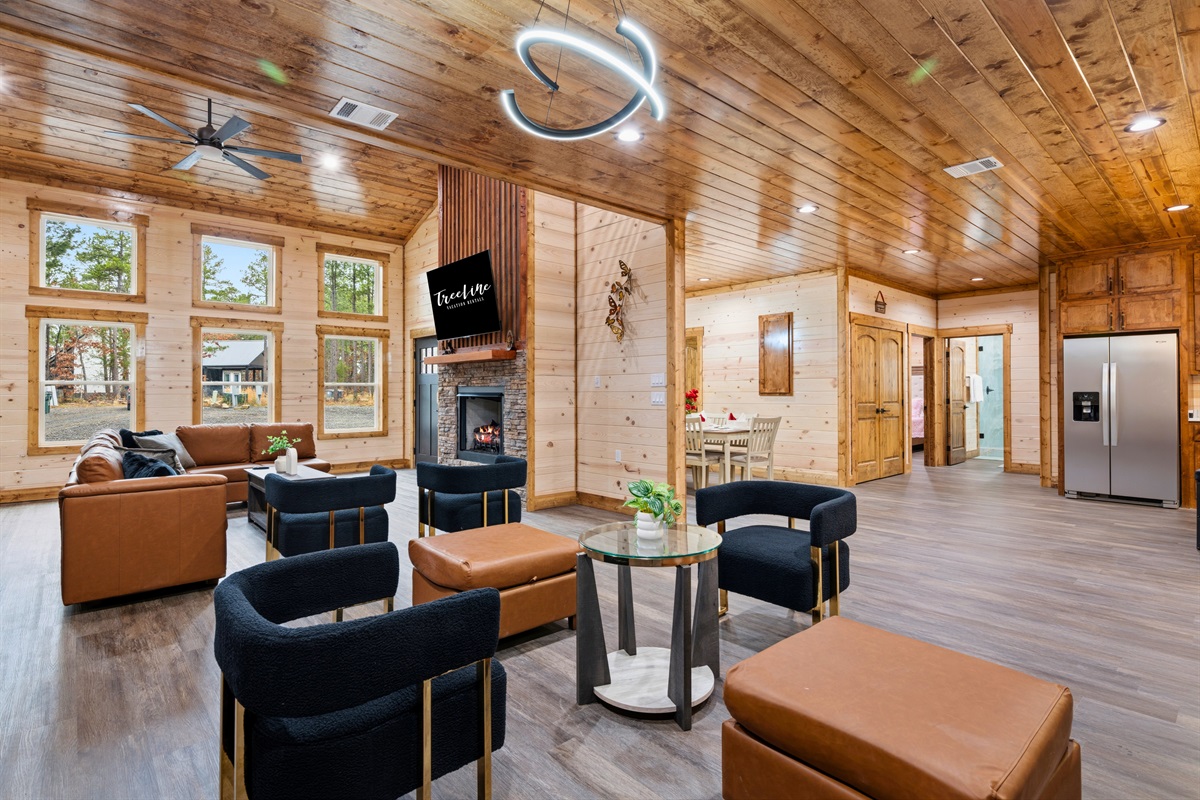 The spacious layout continues into a casual seating area that connects the living room to the kitchen and dining spaces.